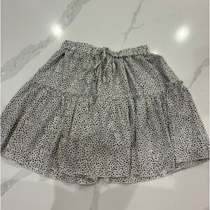 White skirt with black polkadots.